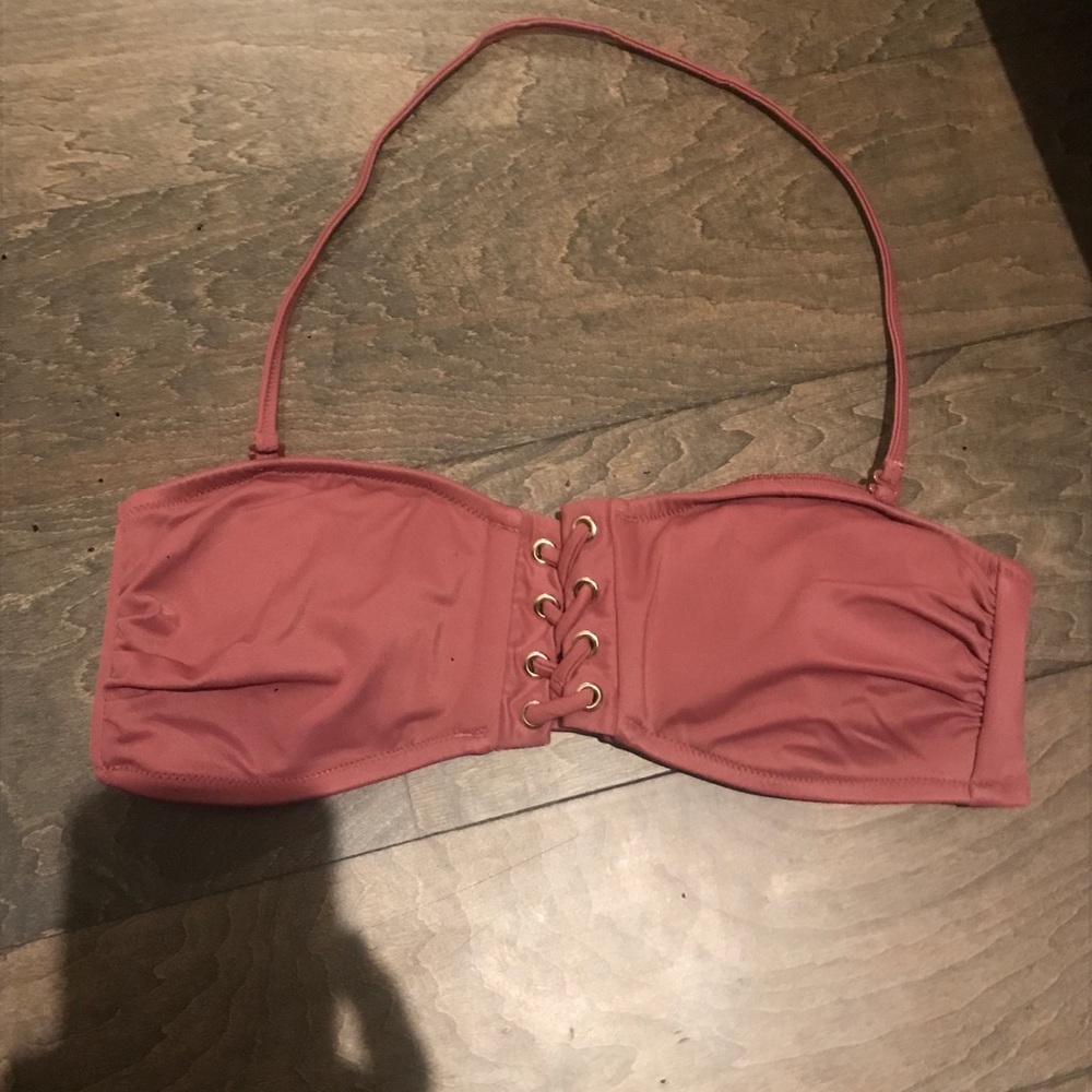 Halter dark pink swimsuit top with opening in the middle.